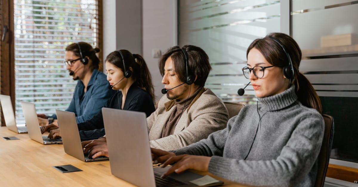 Contact Us A diverse call center team uses laptops and headsets to provide customer support efficiently.